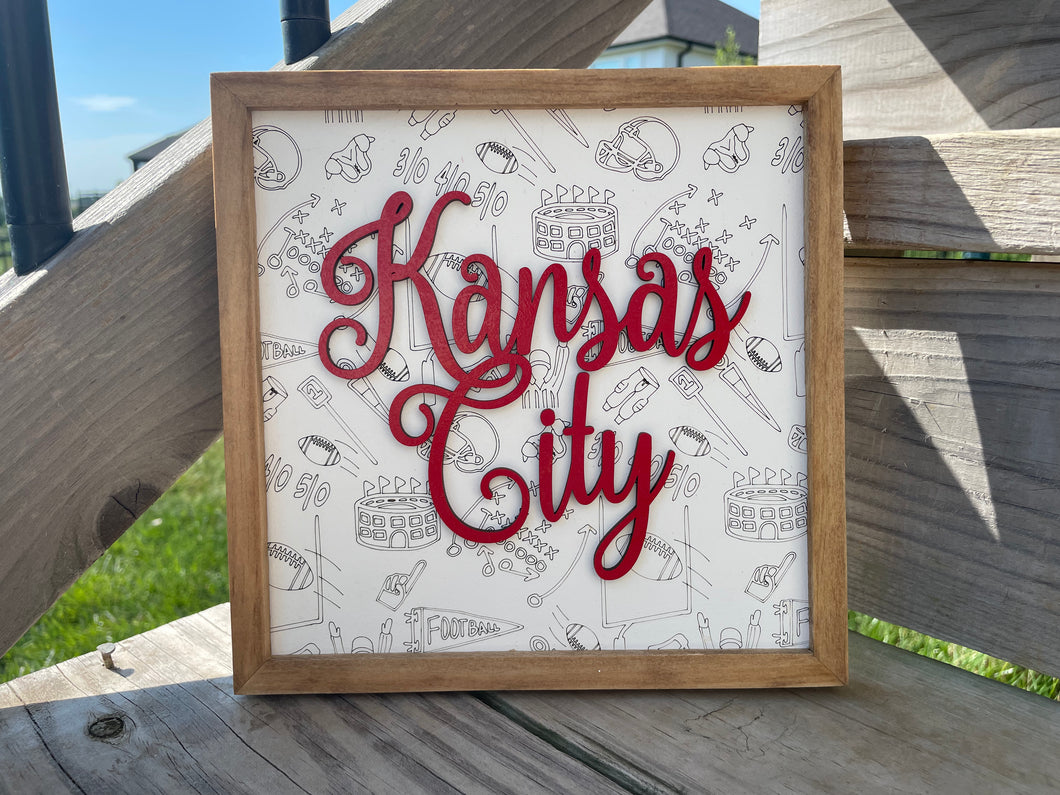 3D Kansas City sign with football background